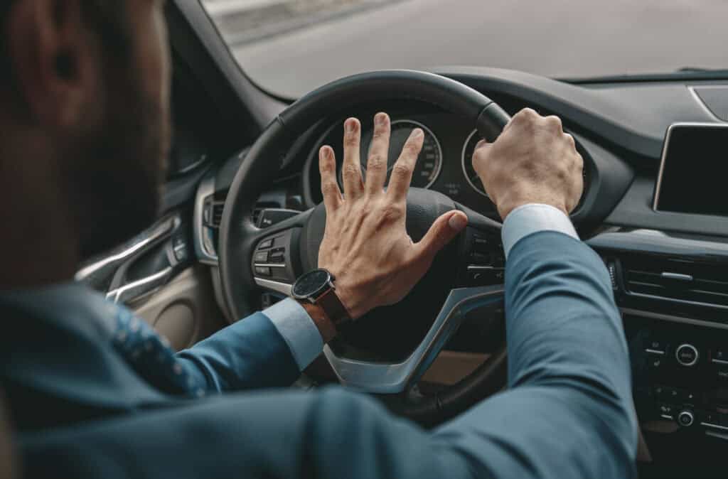 Driver showing aggressive driving behavior behind the wheel.
